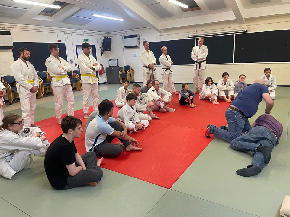 The group observe a demonstration of the recovery position